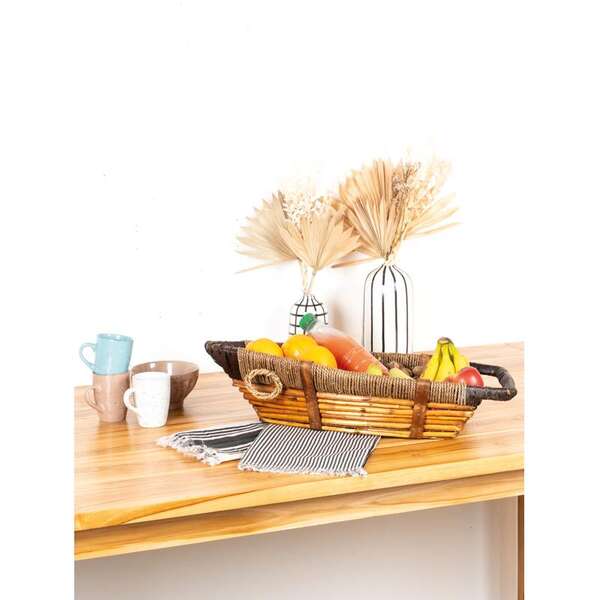 Product image Boat-shaped basket made of dyed wicker, rope and wood.